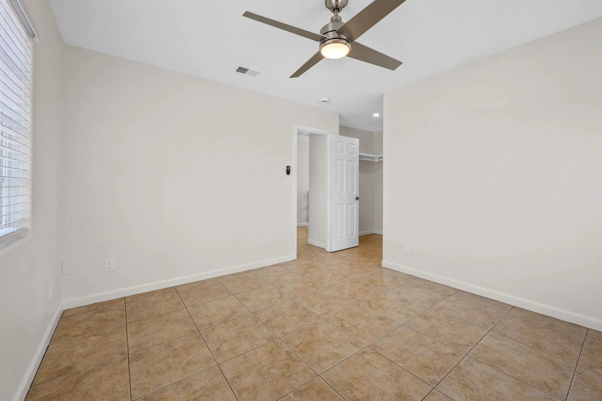 1749-51 Dahlia Avenue San Diego, CA 92154 - Photo 17 of 23 an empty room with fan and entryway