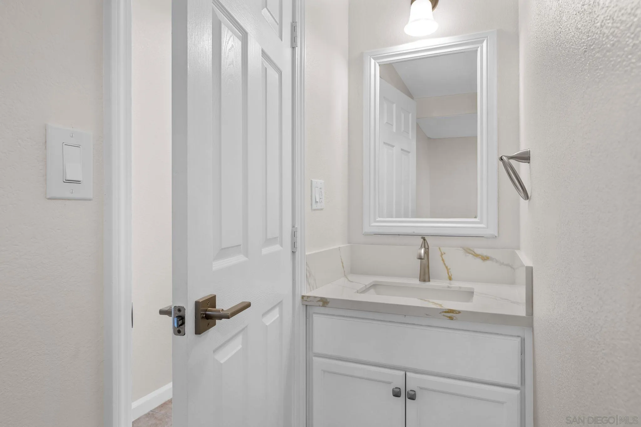 1749-51 Dahlia Avenue San Diego, CA 92154 - Photo 18 of 23 a bathroom with a sink and a mirror