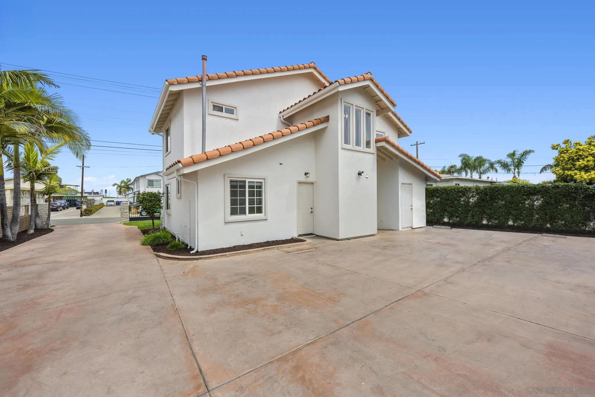 1749-51 Dahlia Avenue San Diego, CA 92154 - Photo 20 of 23 a view of a house with a yard and parking