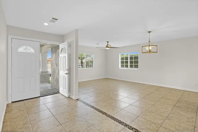 a view of a kitchen with an empty space and a window
