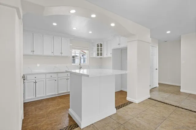 a kitchen with white cabinets