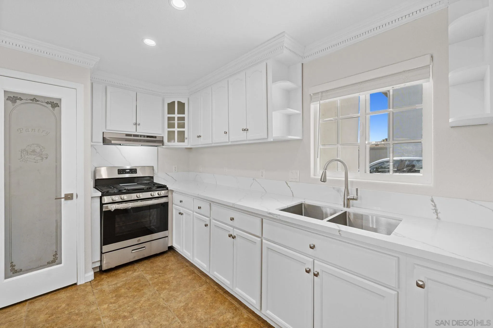 1749-51 Dahlia Avenue San Diego, CA 92154 - Photo 7 of 23 a kitchen with white cabinets and appliances