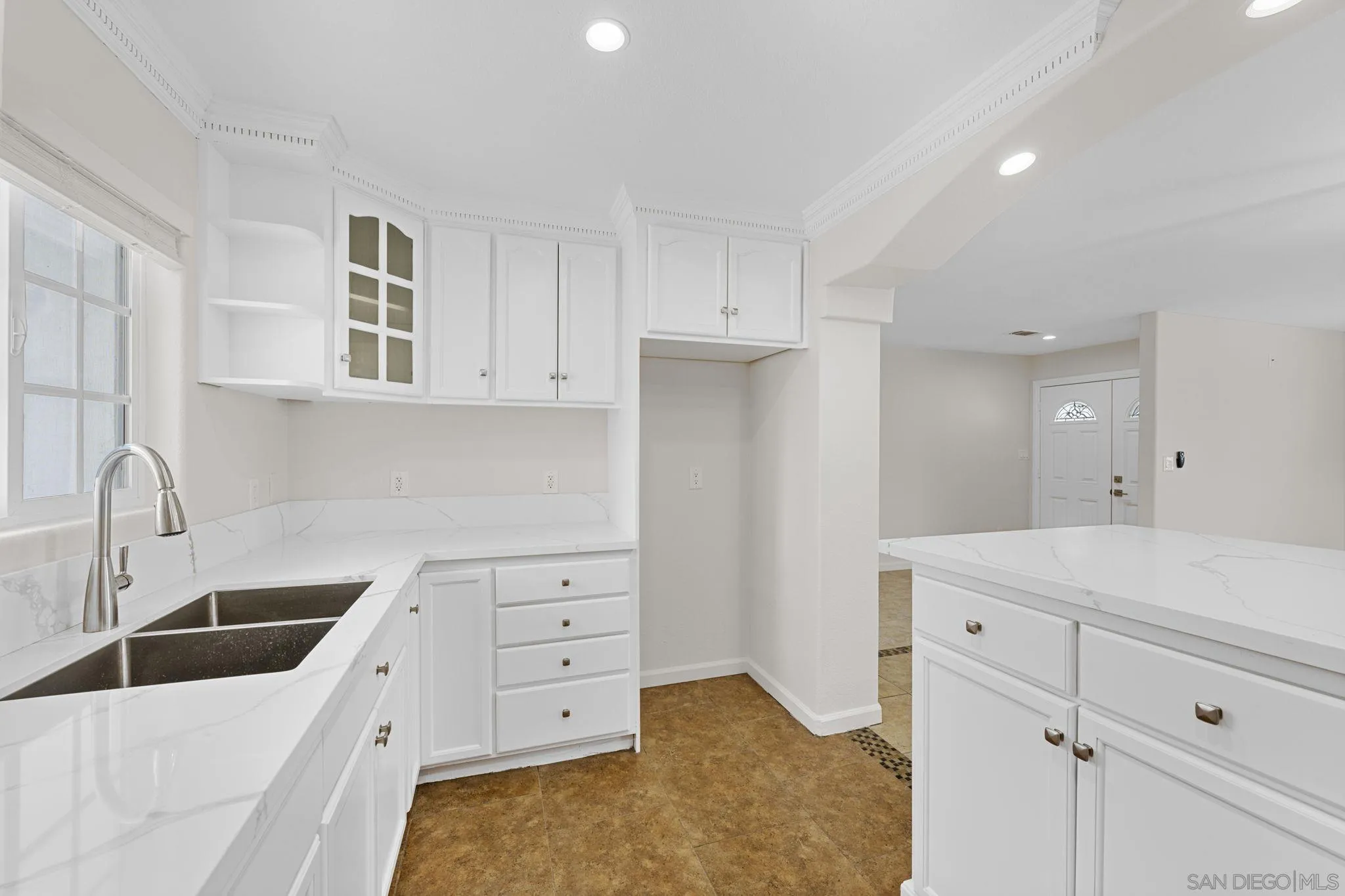 1749-51 Dahlia Avenue San Diego, CA 92154 - Photo 8 of 23 a kitchen that has a lot of white cabinets and a sink