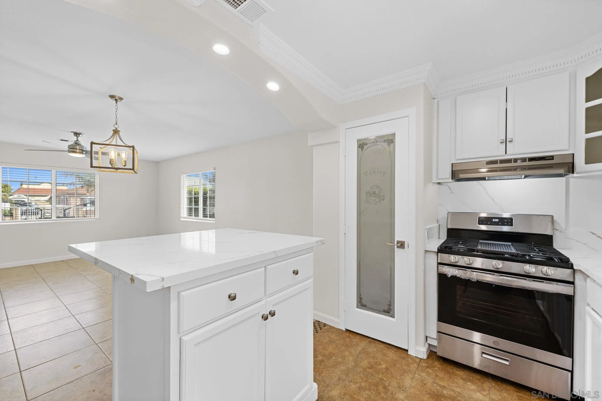 1749-51 Dahlia Avenue San Diego, CA 92154 - Photo 9 of 23 a kitchen with a stove and white cabinets