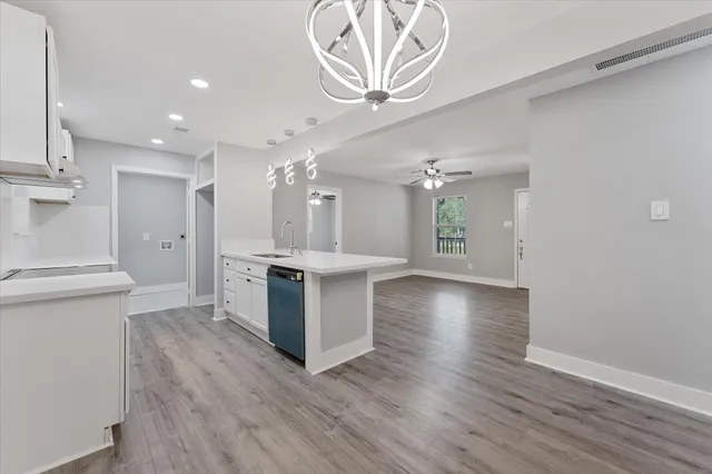 a view of a kitchen with a sink and a stove top oven