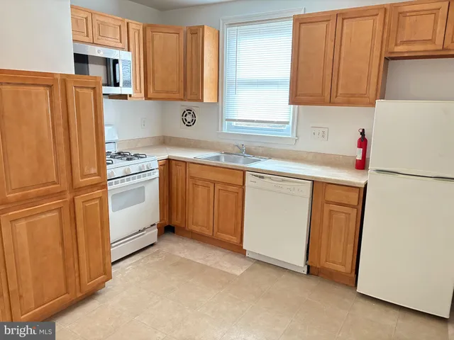 a kitchen with stainless steel appliances granite countertop a refrigerator sink and cabinets