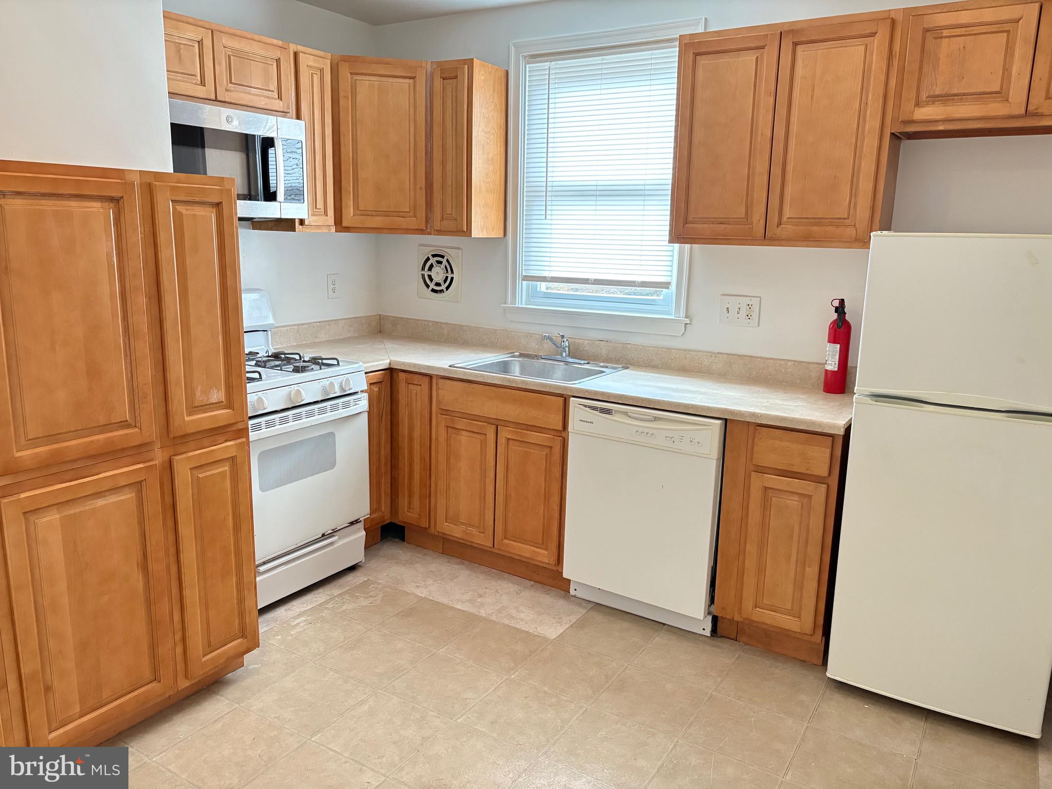 120 Overhill Avenue Philadelphia, PA 19116 - Photo 12 of 16 a kitchen with stainless steel appliances granite countertop a refrigerator sink and cabinets