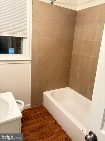 a bathroom with a bathtub and shower