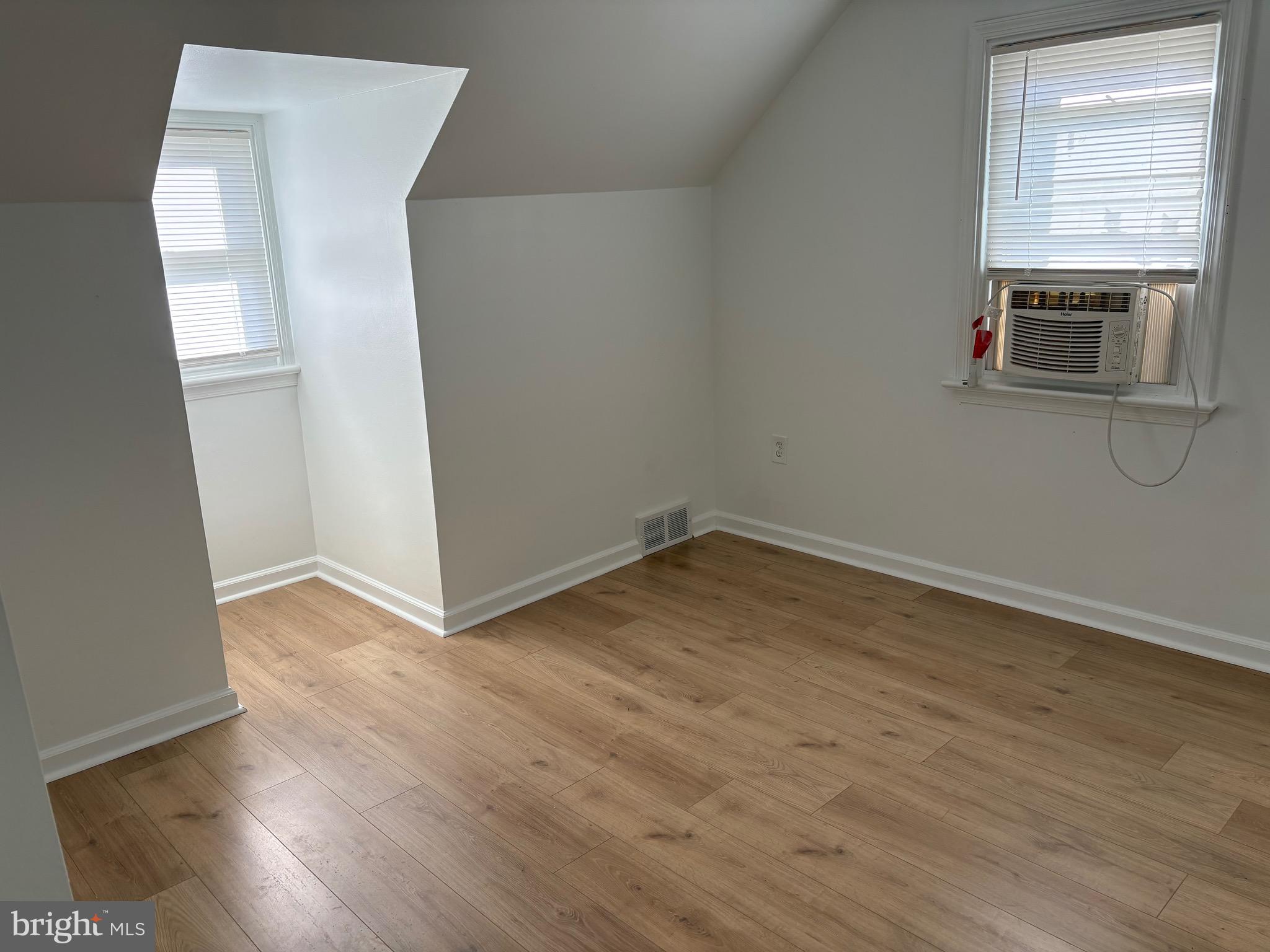 120 Overhill Avenue Philadelphia, PA 19116 - Photo 7 of 16 an empty room with wooden floor and windows