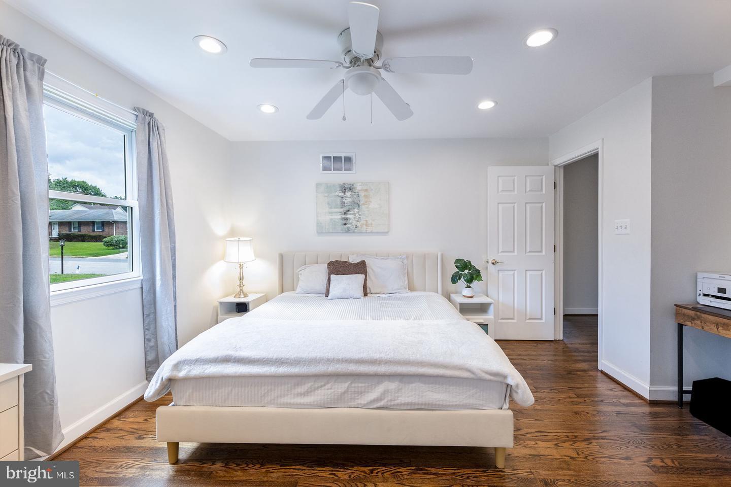 404 Homewood Road Linthicum Heights, MD 21090 - Photo 14 of 24 a spacious bedroom with a large bed and a chandelier