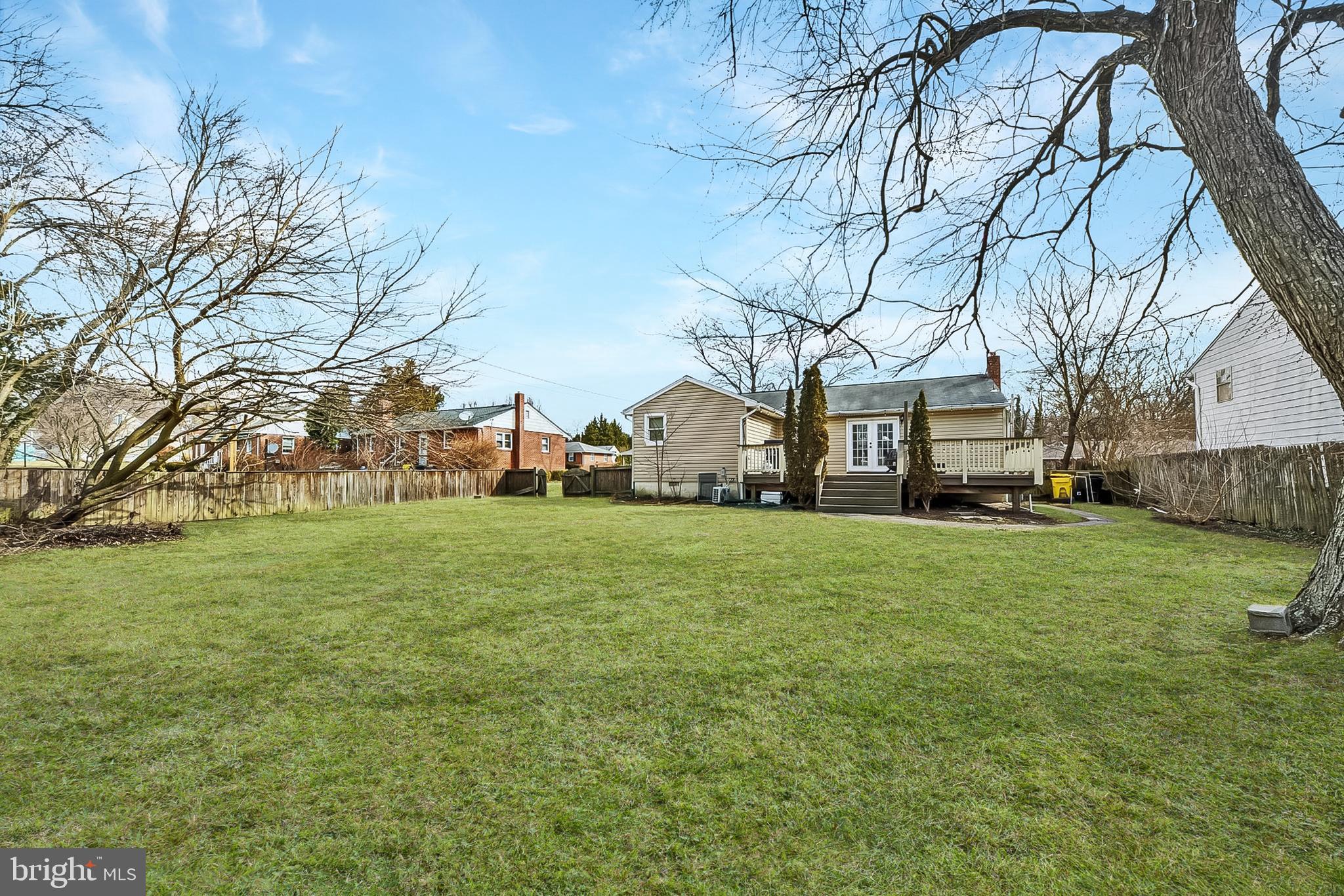 404 Homewood Road Linthicum Heights, MD 21090 - Photo 2 of 24 a view of a large house with a big yard and large trees
