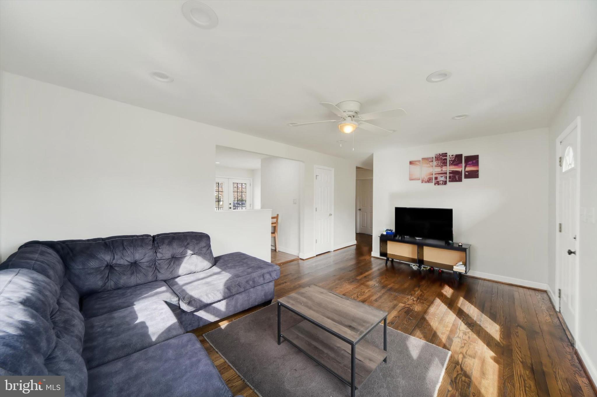 404 Homewood Road Linthicum Heights, MD 21090 - Photo 7 of 24 a living room with furniture a rug and a flat screen tv
