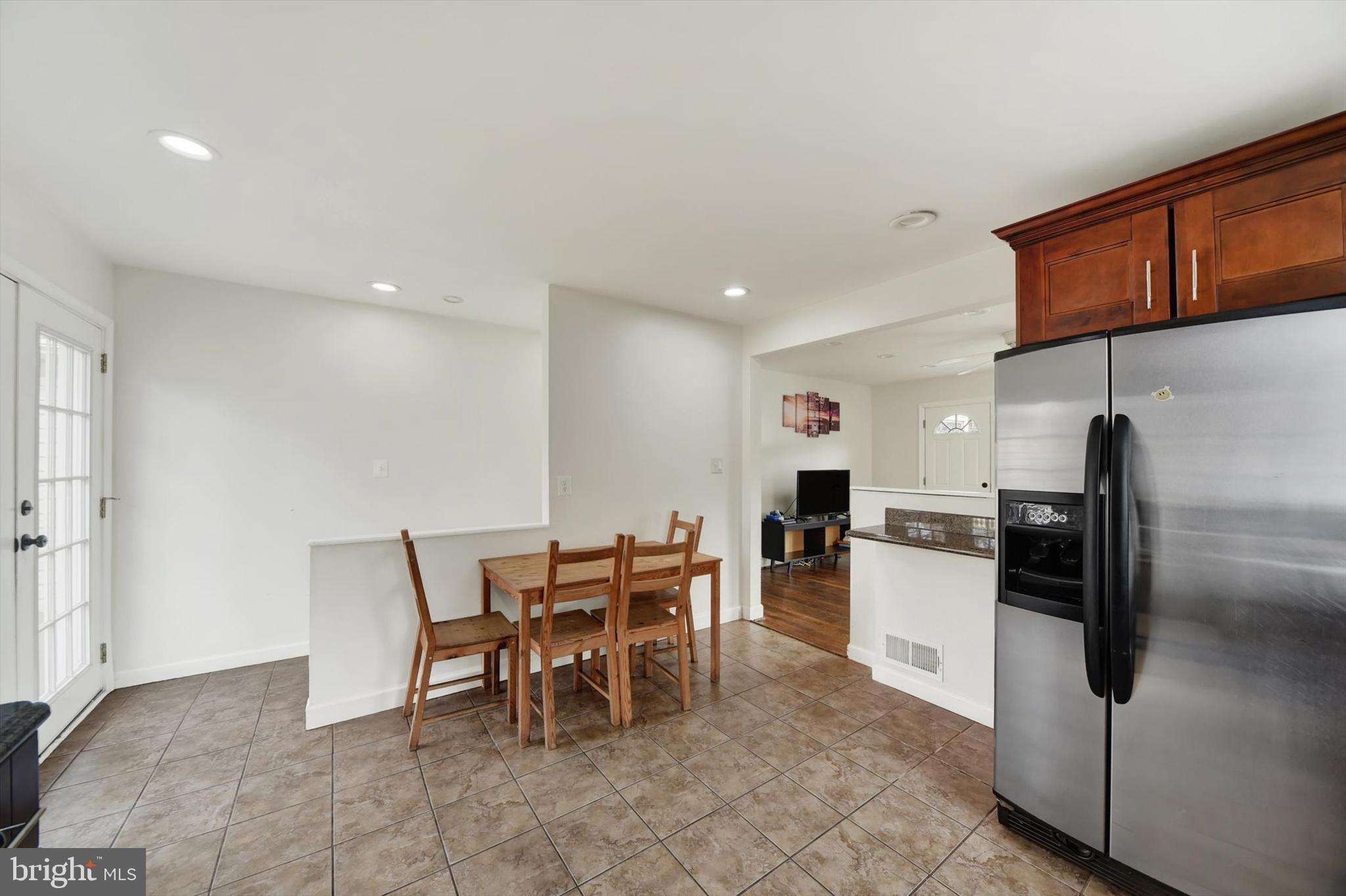 404 Homewood Road Linthicum Heights, MD 21090 - Photo 9 of 24 a kitchen with stainless steel appliances kitchen island granite countertop a refrigerator and a stove top oven