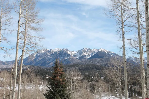 a view of a building with snow on the road