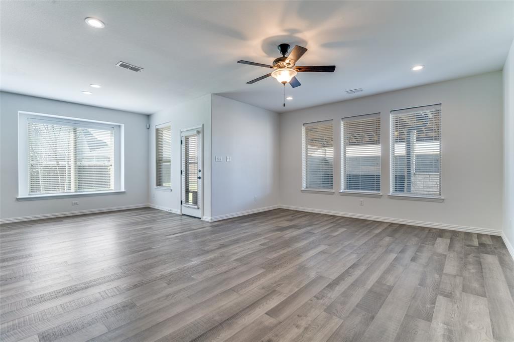 1215 Hundgate Way Forney, TX 75126 - Photo 15 of 38 Another view of the living area with high ceilings and view of the backyard area