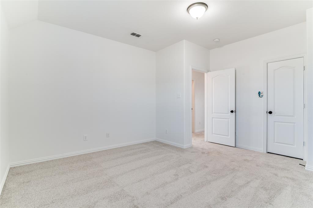 1215 Hundgate Way Forney, TX 75126 - Photo 35 of 38 Upstairs bedroom #4 featuring light colored carpet and baseboards with a walk-in closet
