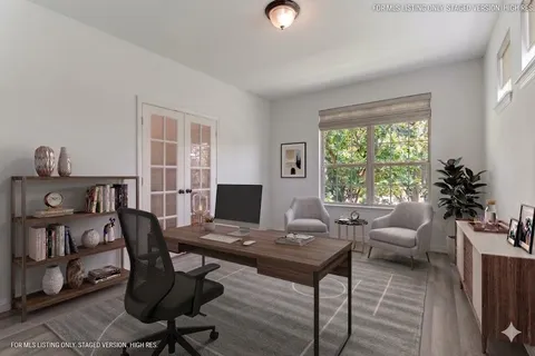 a view of a workspace with a window and lounge chair