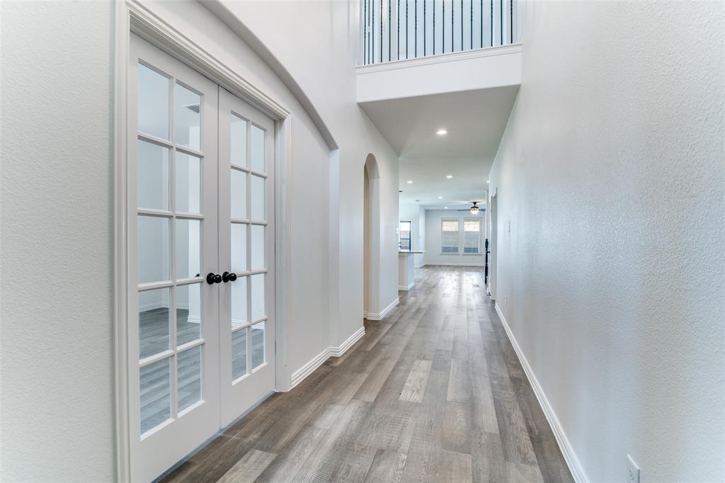 1215 Hundgate Way Forney, TX 75126 - Photo 6 of 38 Hallway with light wood finished floors, arched walkways, a textured wall, recessed lighting, and french doors leading to the office