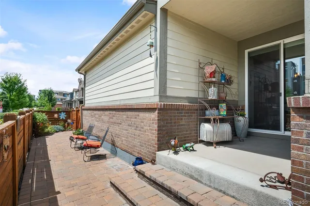 a backyard of a house with barbeque oven table and chairs
