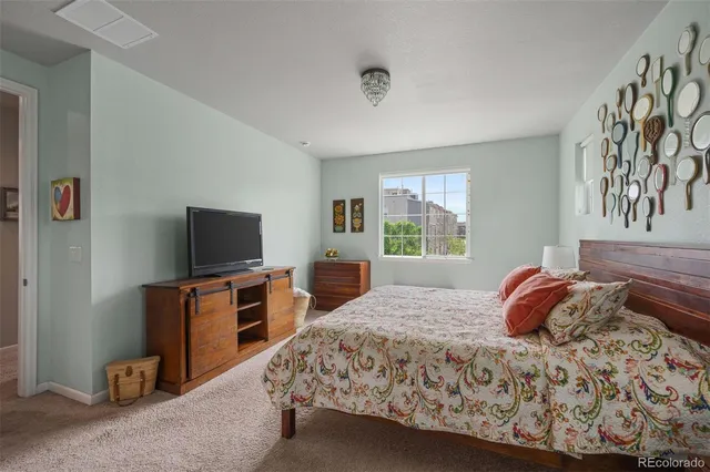 a bedroom with a bed and flat screen tv