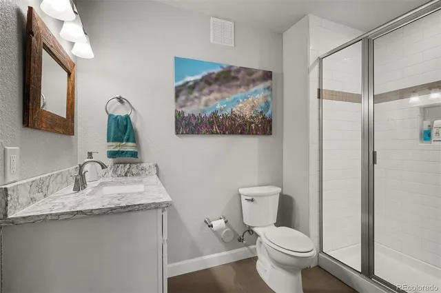 a bathroom with a toilet a sink and a mirror