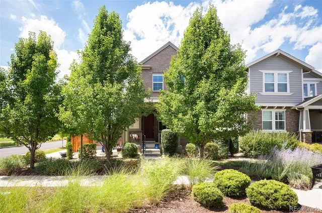 a view of a house with swimming pool and a garden