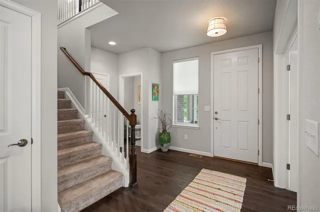 a view of entryway and hall with wooden floor