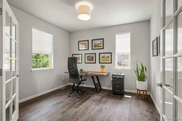 a workspace with wooden floor and a window