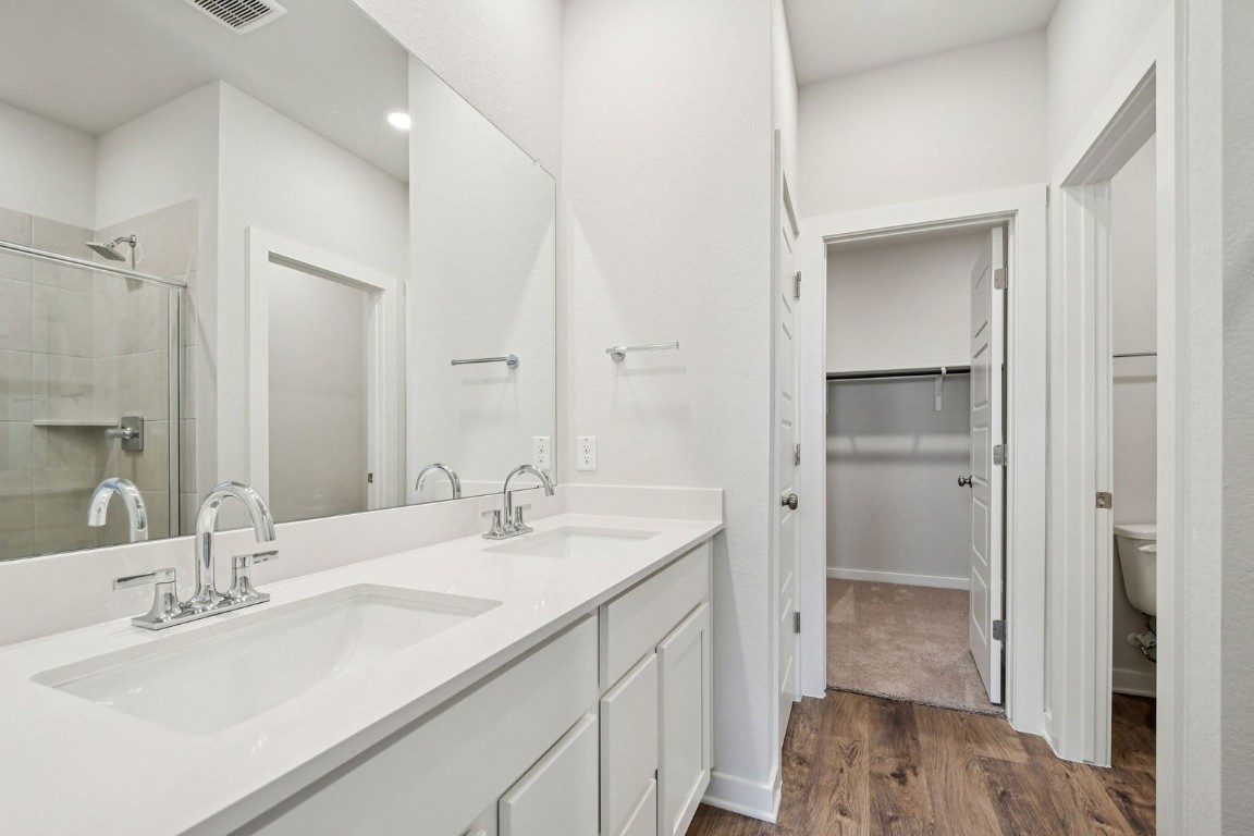 13413 Derby Ride Drive Buda, TX 78610 - Photo 14 of 36 a bathroom with a sink and a mirror