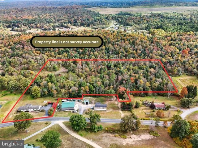 an aerial view of residential houses with outdoor space and swimming pool