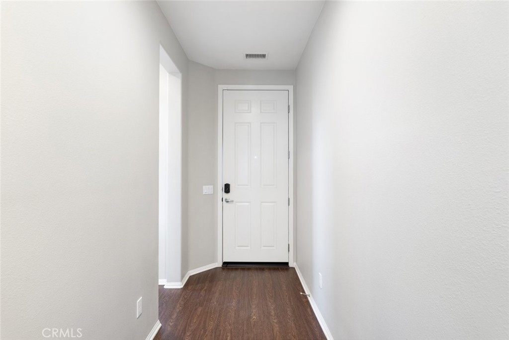25451 Jack Rabbit Lane Corona, CA 92883 - Photo 11 of 75 a view of a hallway with wooden floor