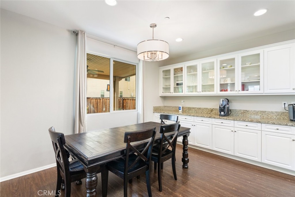 25451 Jack Rabbit Lane Corona, CA 92883 - Photo 15 of 75 a view of a dining room with furniture window and wooden floor