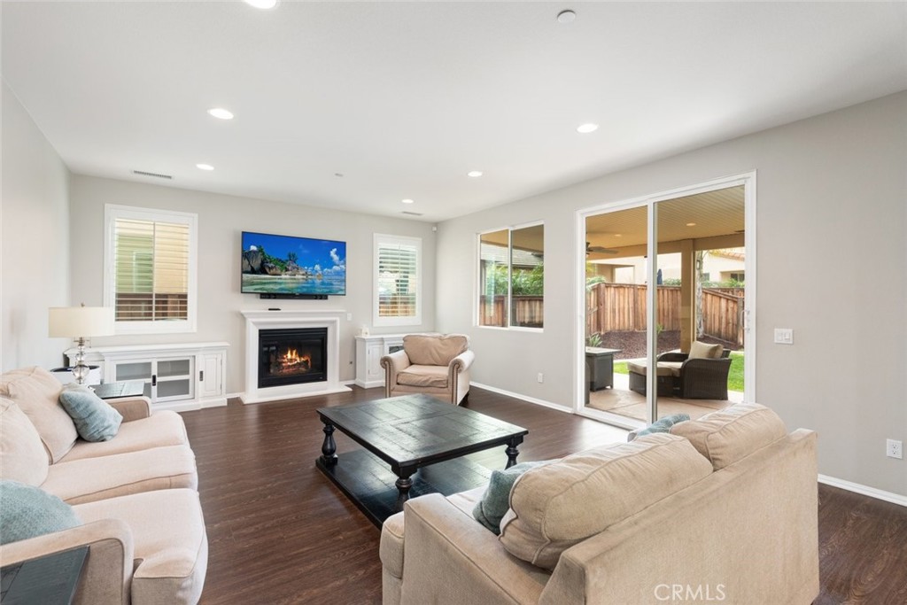 25451 Jack Rabbit Lane Corona, CA 92883 - Photo 16 of 75 a living room with furniture a fireplace and a table