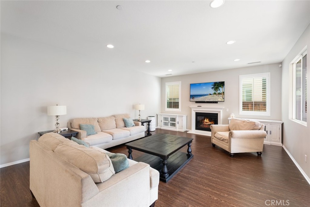 25451 Jack Rabbit Lane Corona, CA 92883 - Photo 17 of 75 a living room with furniture flat screen tv and a fireplace