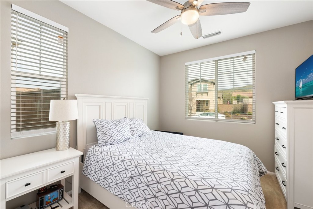 25451 Jack Rabbit Lane Corona, CA 92883 - Photo 19 of 75 a bedroom with a bed and a window
