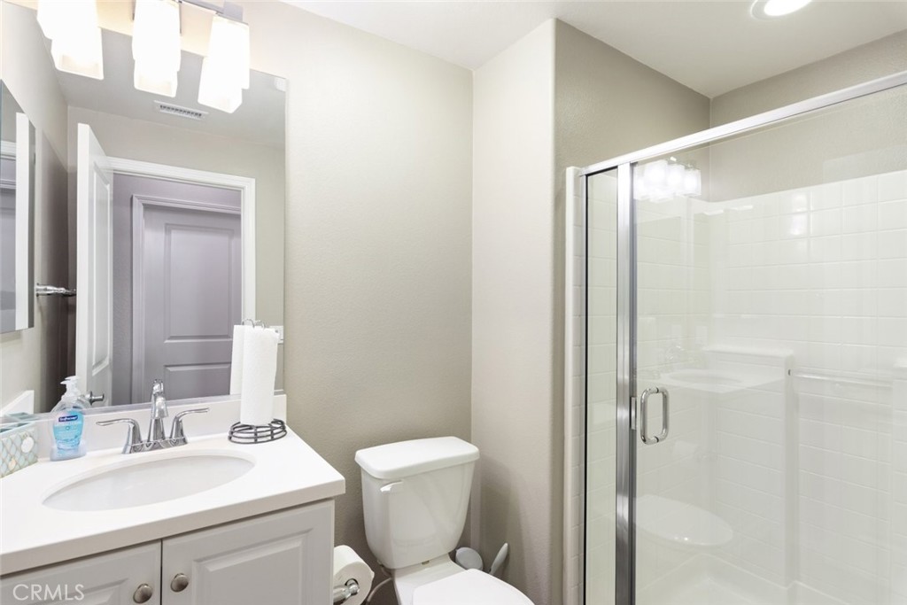 25451 Jack Rabbit Lane Corona, CA 92883 - Photo 20 of 75 a bathroom with a toilet a sink and a mirror