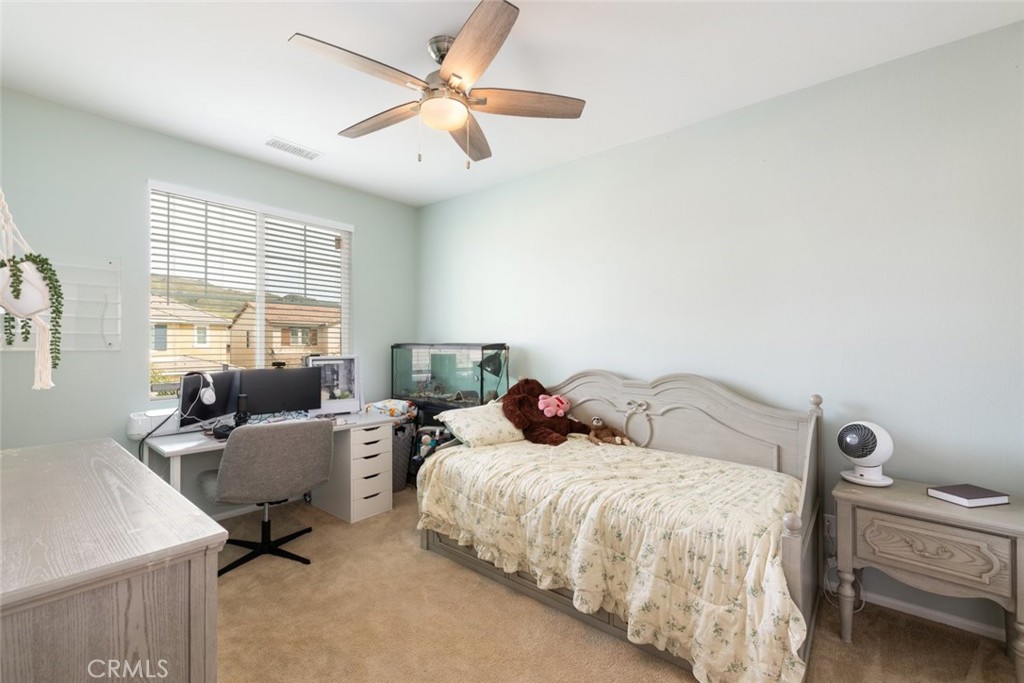 25451 Jack Rabbit Lane Corona, CA 92883 - Photo 25 of 75 a bedroom with a bed and wooden floor