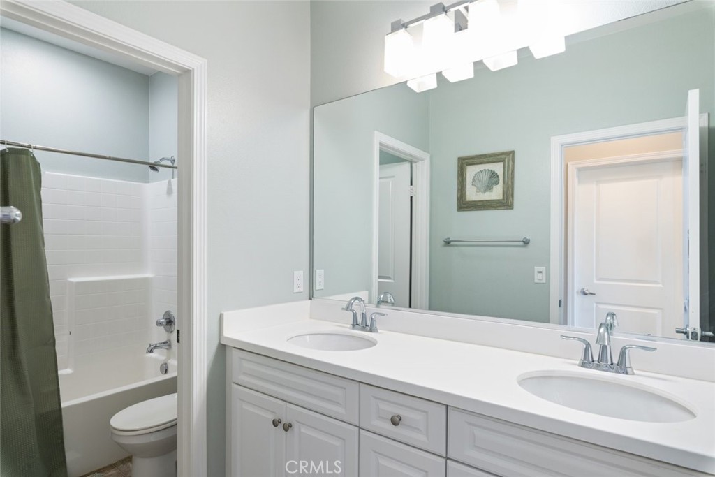 25451 Jack Rabbit Lane Corona, CA 92883 - Photo 26 of 75 a bathroom with a sink a toilet and shower