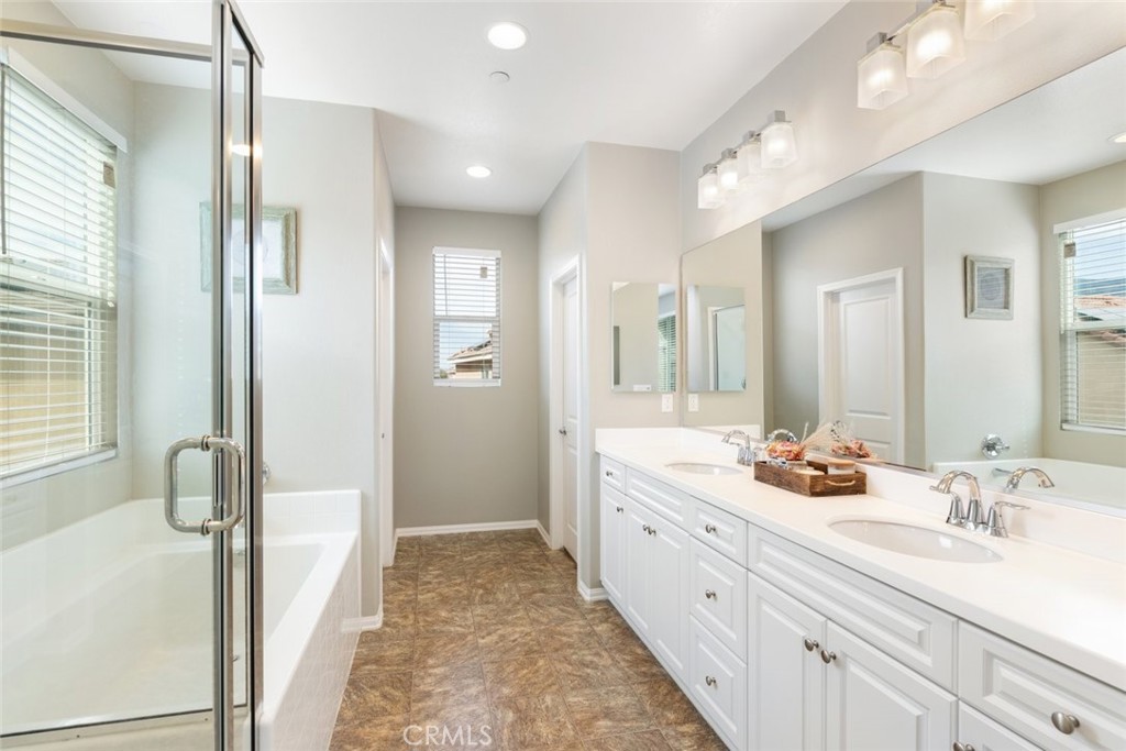 25451 Jack Rabbit Lane Corona, CA 92883 - Photo 31 of 75 a bathroom with a double vanity sink mirror and