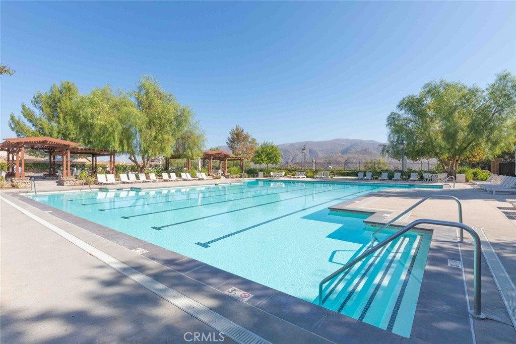 25451 Jack Rabbit Lane Corona, CA 92883 - Photo 59 of 75 a view of a swimming pool with lawn chairs and plants