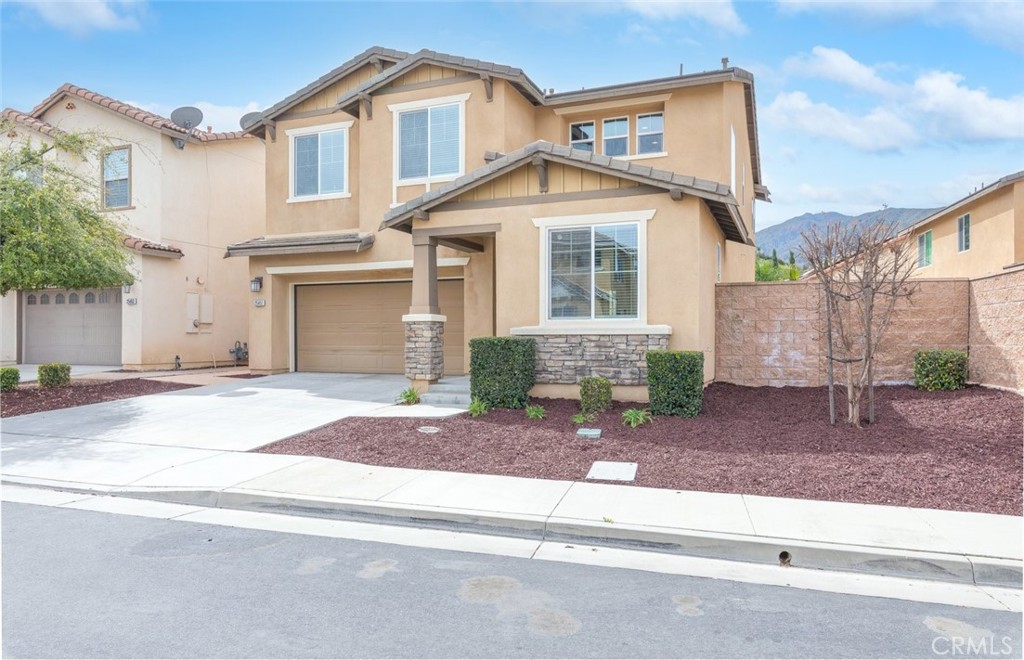 25451 Jack Rabbit Lane Corona, CA 92883 - Photo 6 of 75 a front view of a house with a yard and garage