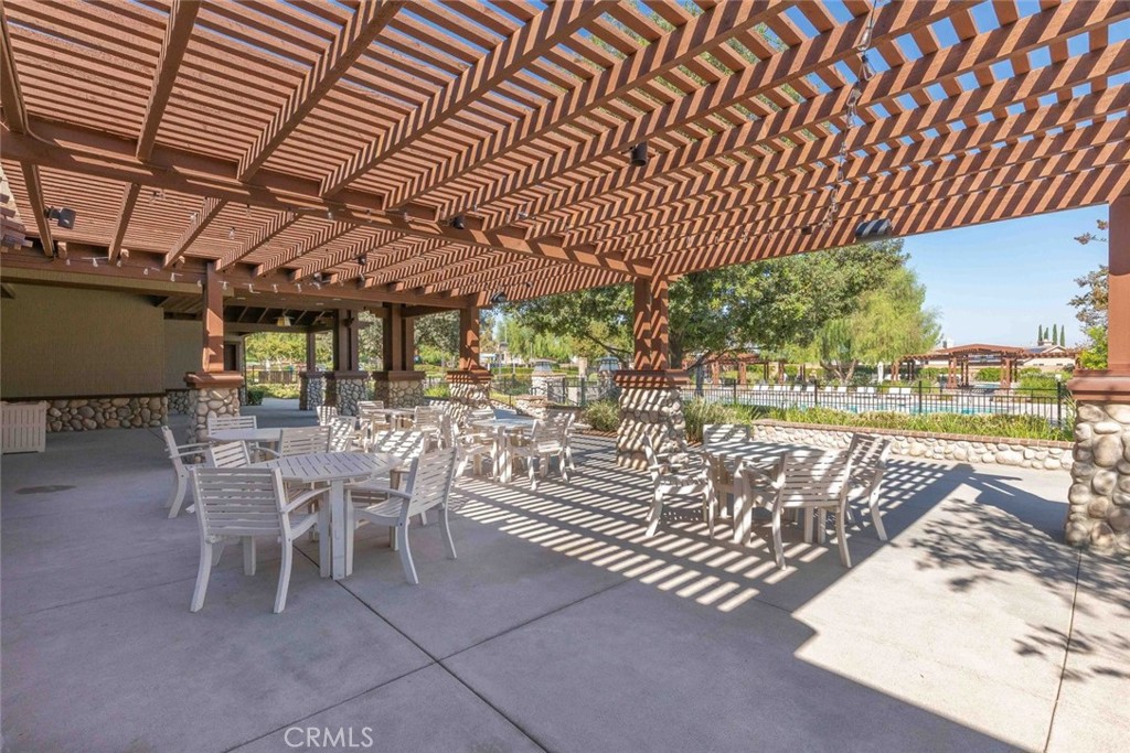 25451 Jack Rabbit Lane Corona, CA 92883 - Photo 67 of 75 a view of a patio with table and chairs with wooden floor
