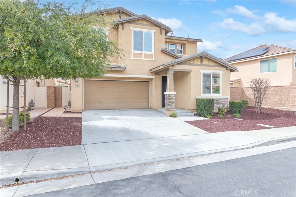 25451 Jack Rabbit Lane Corona, CA 92883 - Photo 7 of 75 a front view of a house with a yard and garage