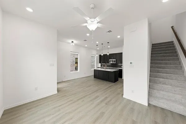 a view of kitchen with refrigerator and microwave