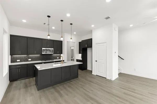 a large kitchen with stainless steel appliances lots of counter top space
