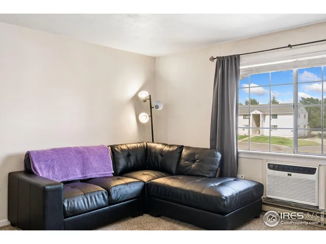 a living room with a couch and a window