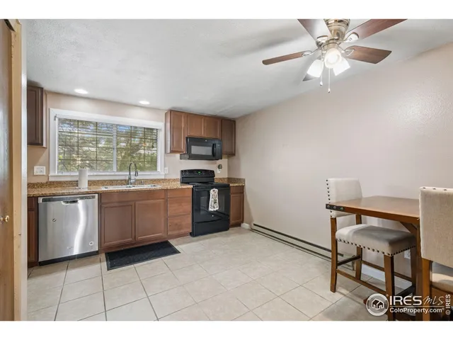 a kitchen with a stove a sink and a refrigerator