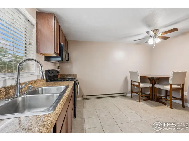 a kitchen with a sink cabinets and window