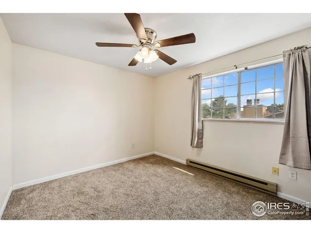 a view of a livingroom with a ceiling fan and wooden floor