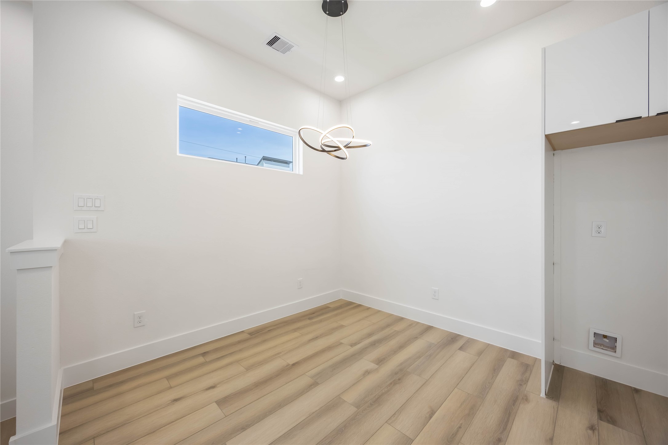 6735 Peerless Street, Unit C Houston, TX 77021 - Photo 6 of 27 a view of a room with wooden floor and white walls